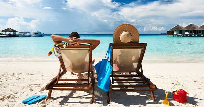 Couple sitting on chairs on the beach
